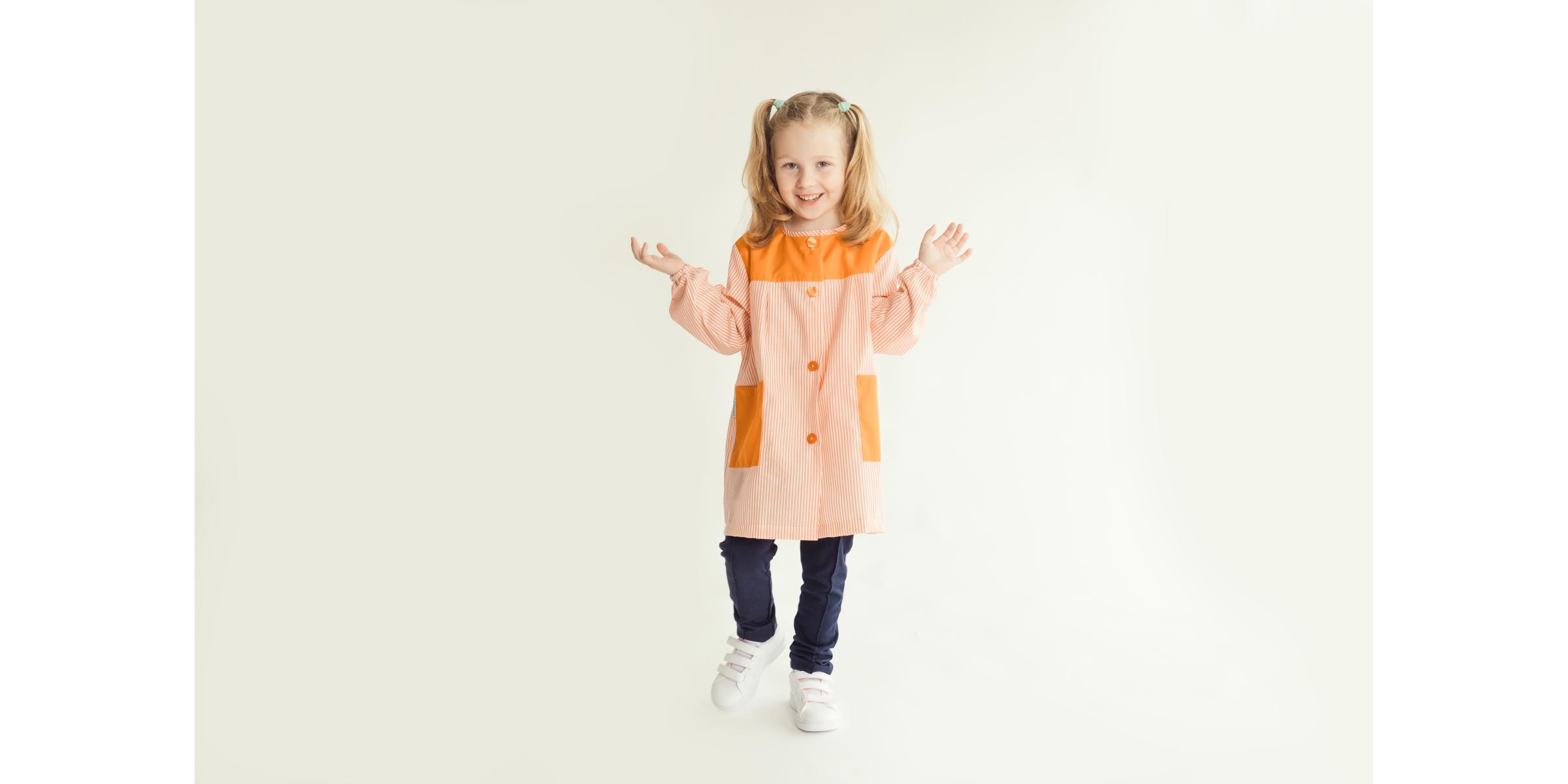 Modèle portant une blouse scolaire pour école avec une rayure orange